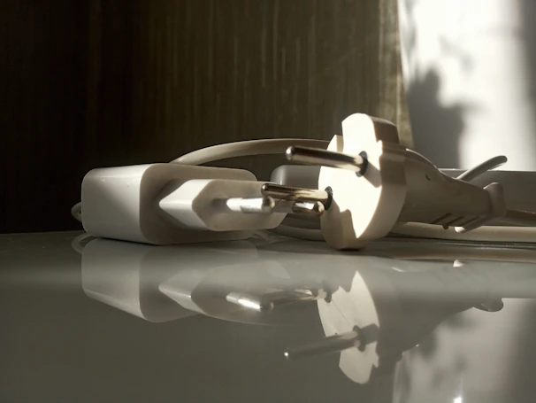 Close-up of a sophisticated travel adapter set on a clean white surface with soft natural light.