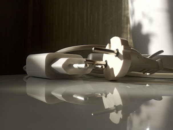 Close-up of a technician inspecting a 3-400w power adapter with precision tools.