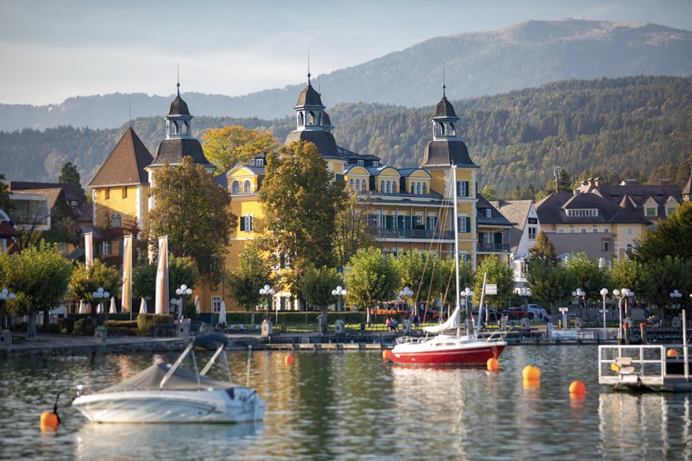 a boat is in the water in front of a large building