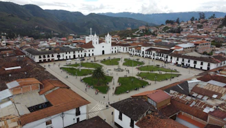 an aerial view of a city with a church in the center