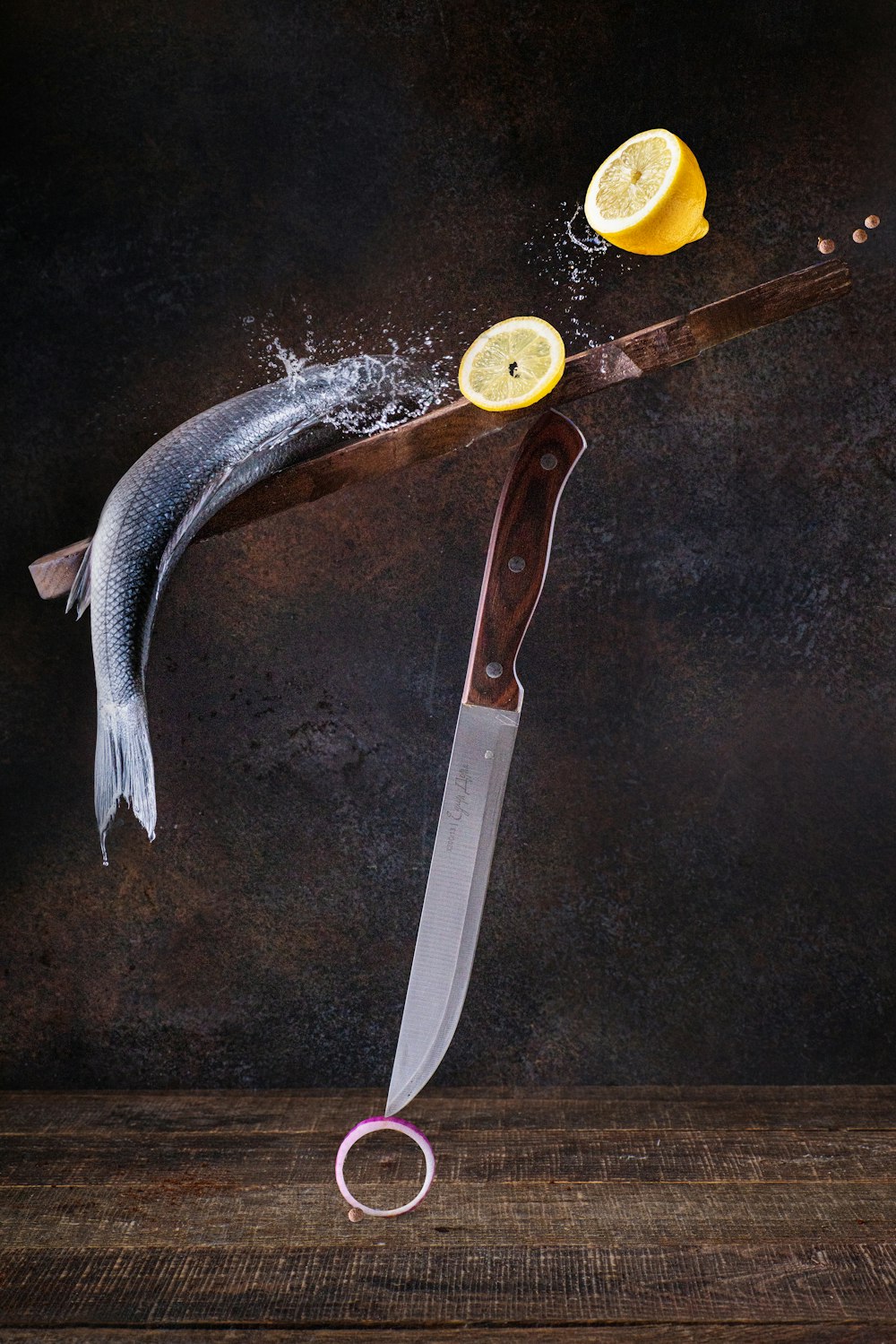 a knife and a lemon on a table