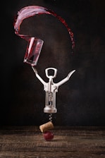 a wine glass being poured into a corkscrew