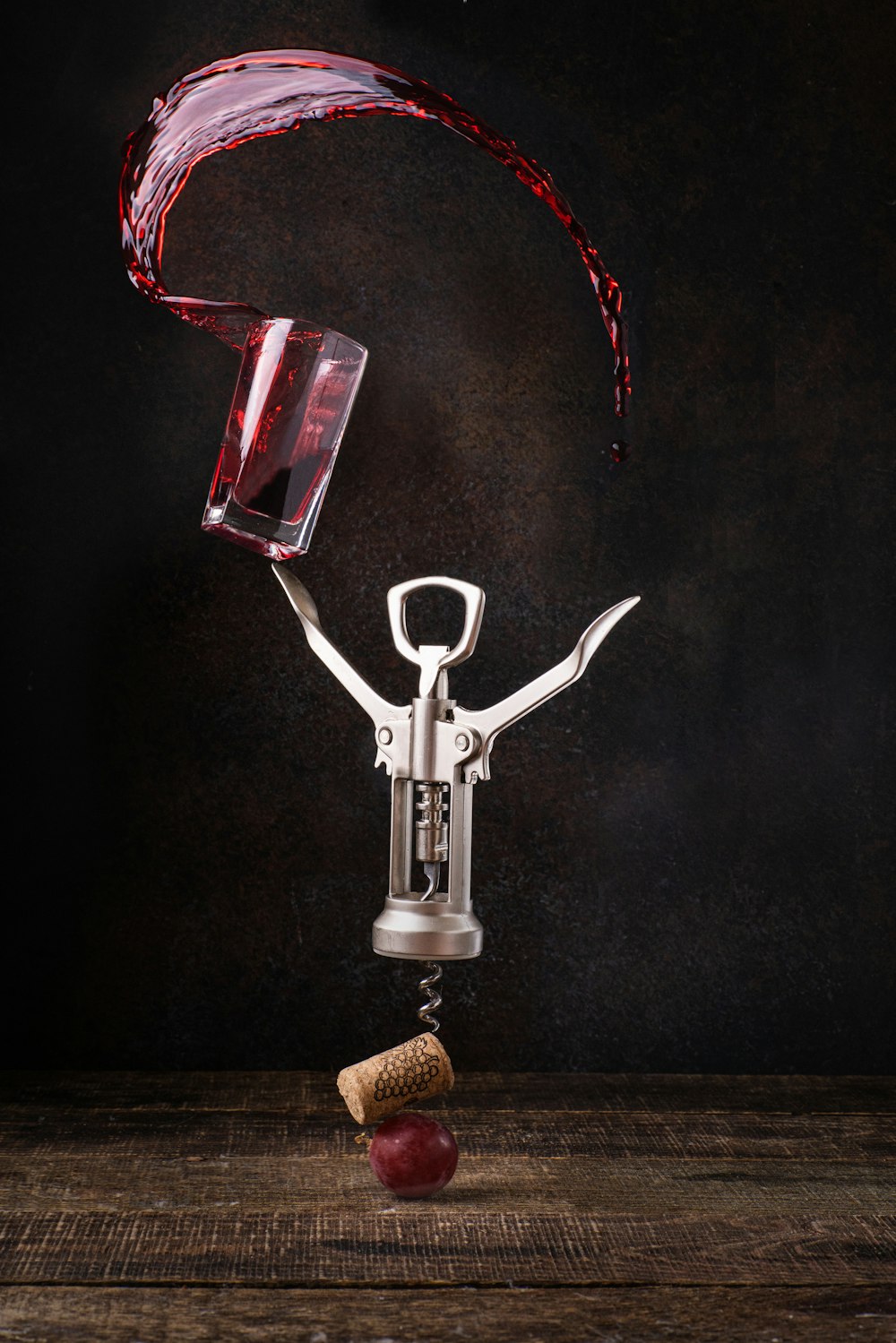 a wine glass being poured into a corkscrew