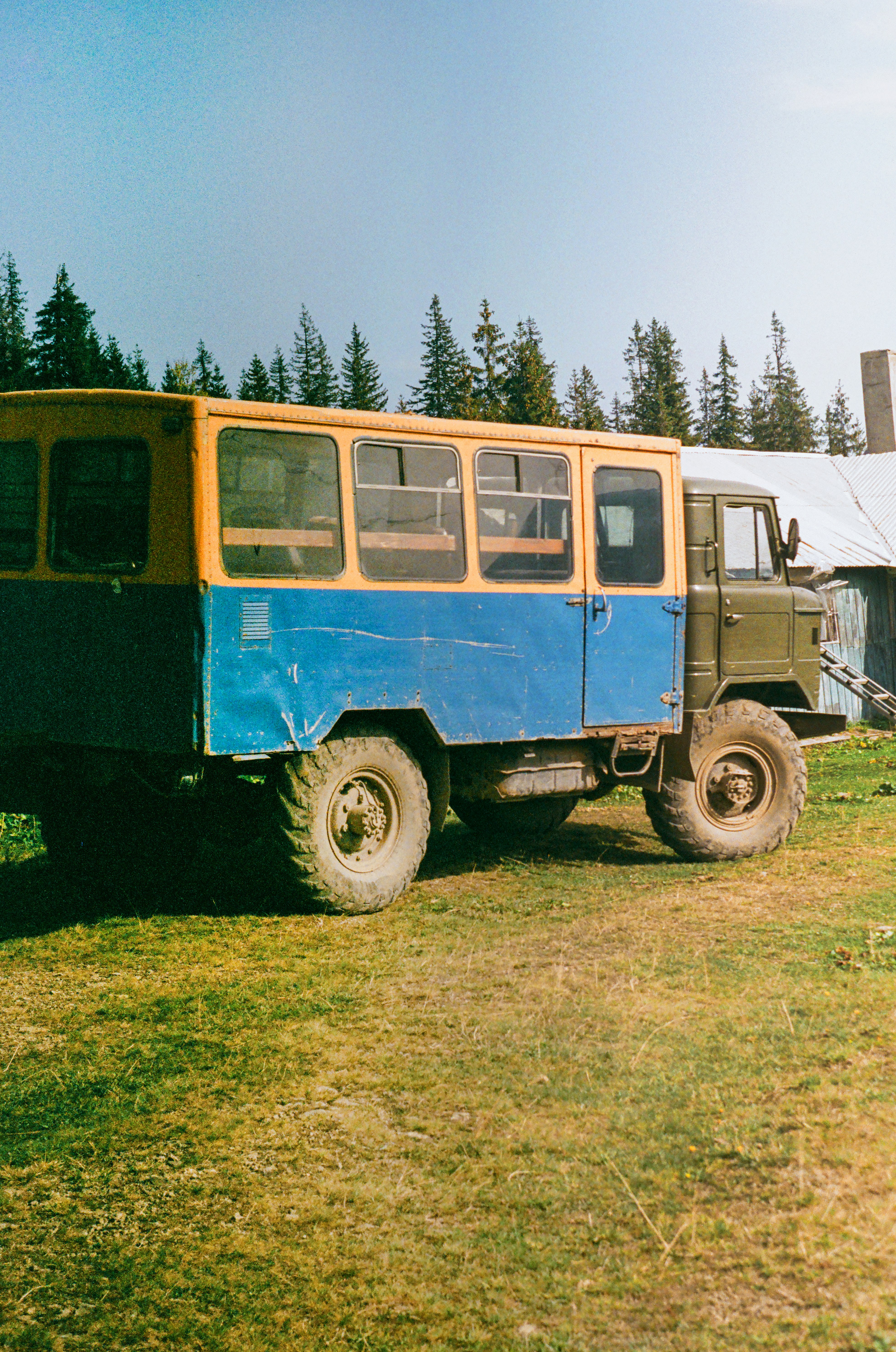 A vintage bus in ukrainian village on film.