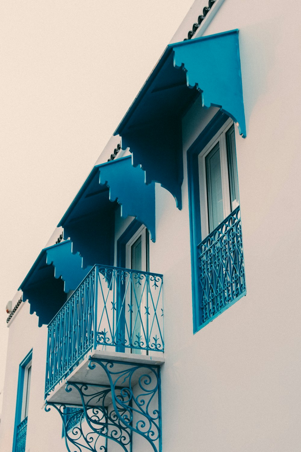 a building with blue balconies and a balcony