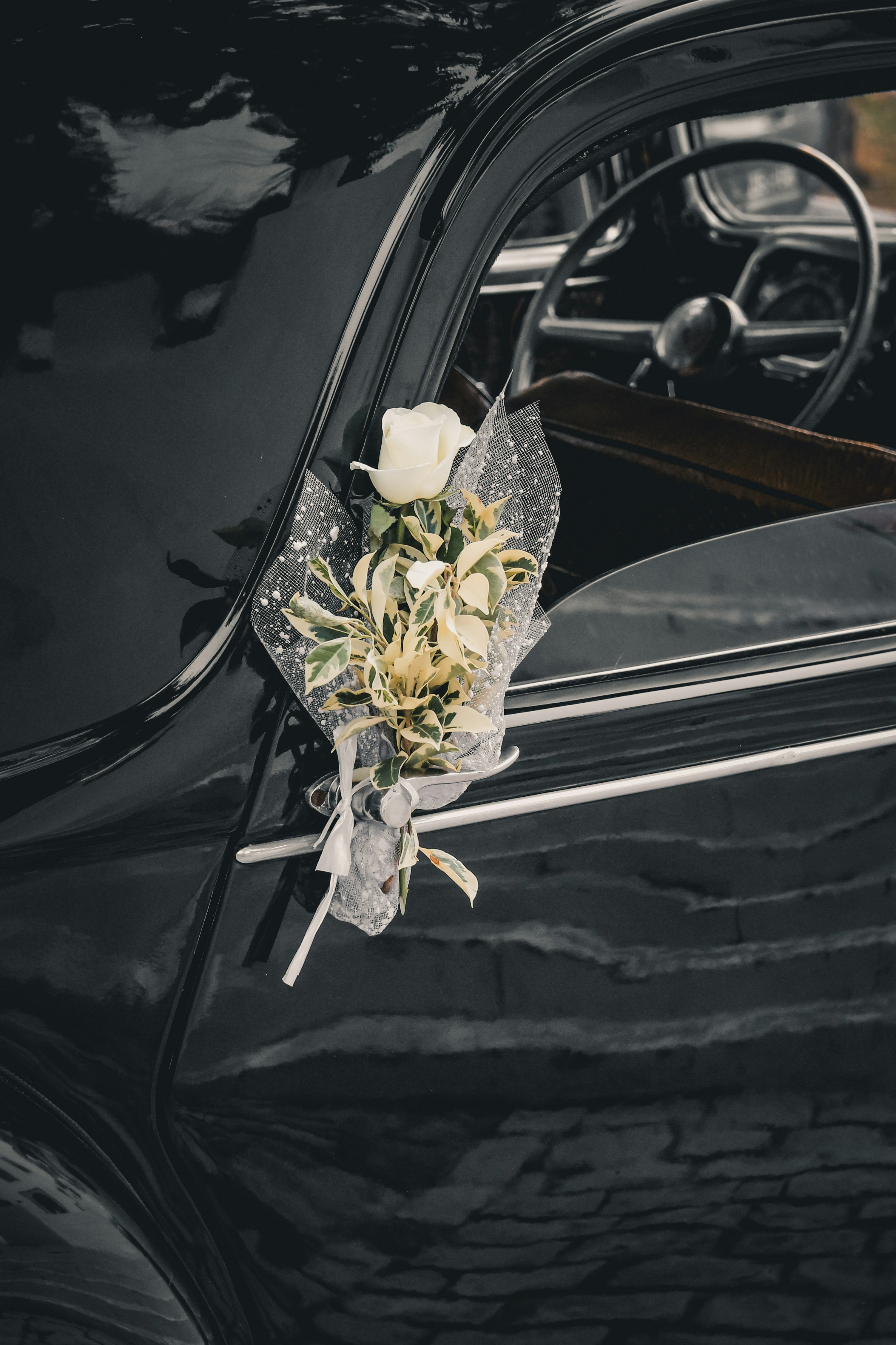 a bouquet of flowers is placed on the door of a car