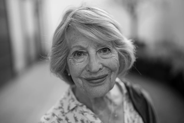 a black and white photo of a woman smiling