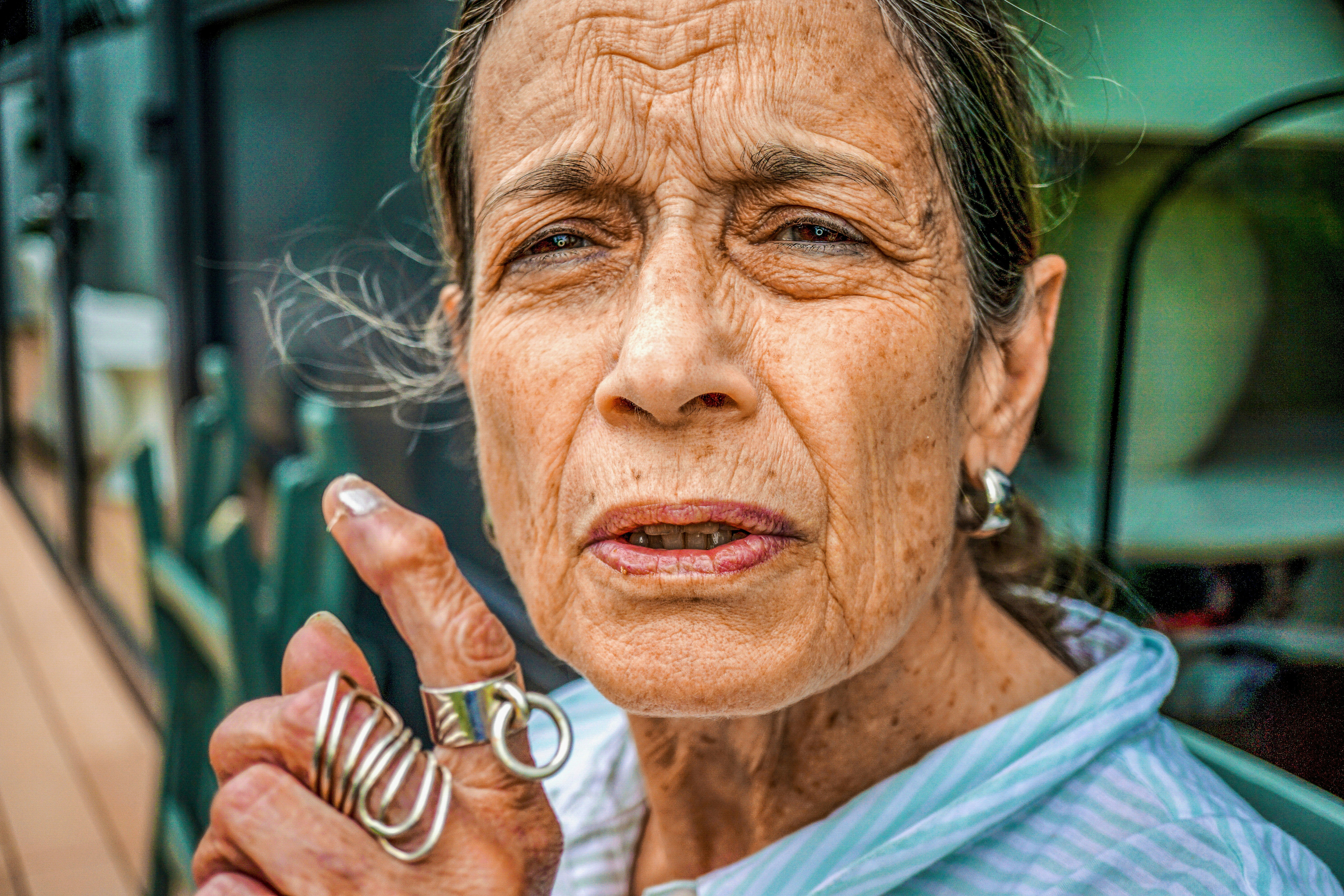 A close-up of an elderly woman proudly displaying her inked finger after voting.