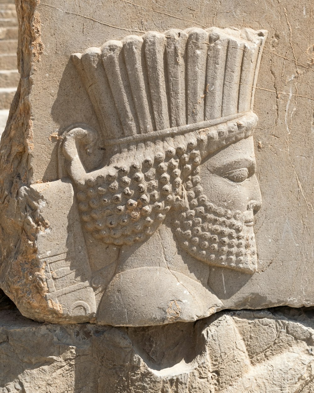 a close up of a statue of a man with a headdress