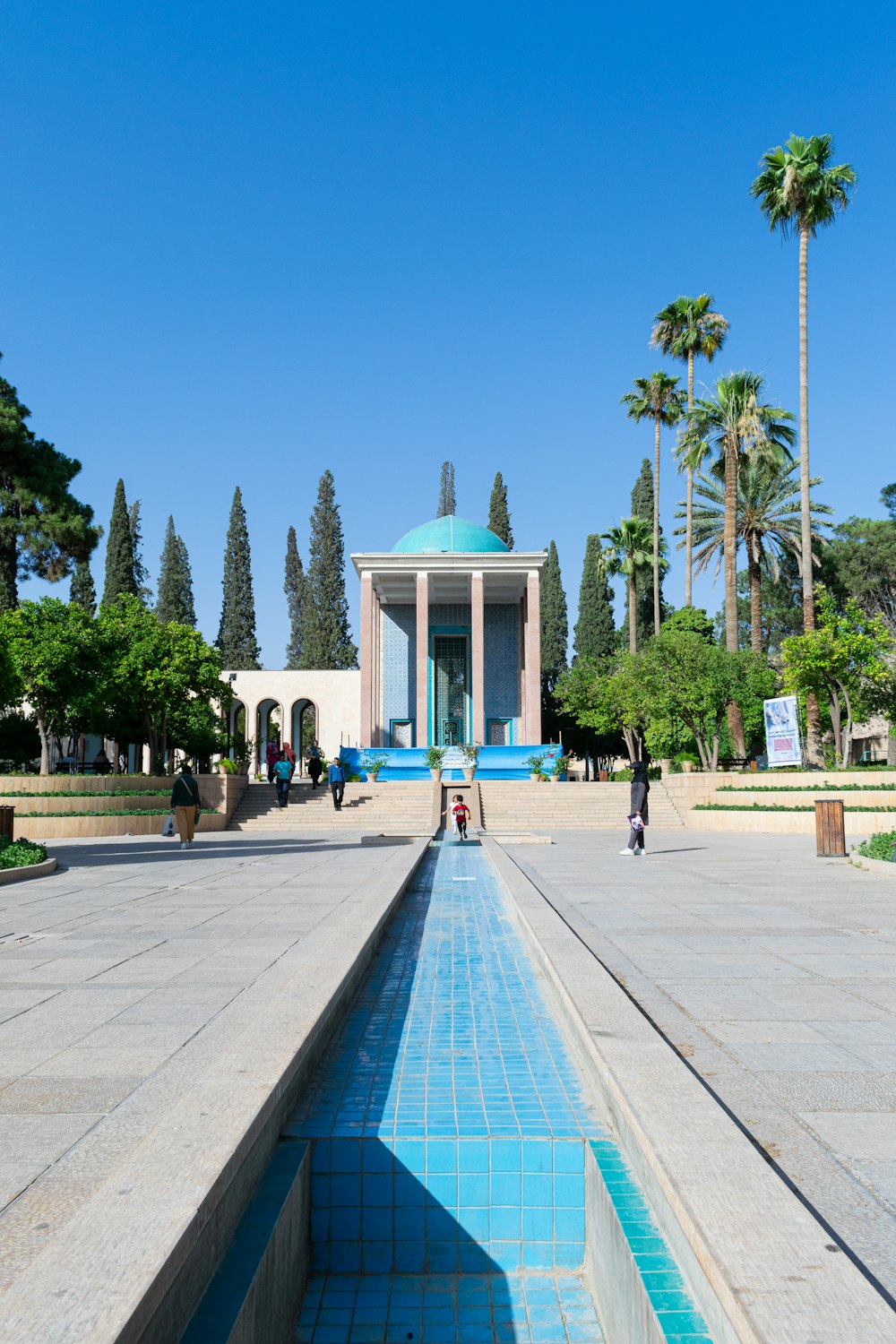 a long pool of water in front of a building