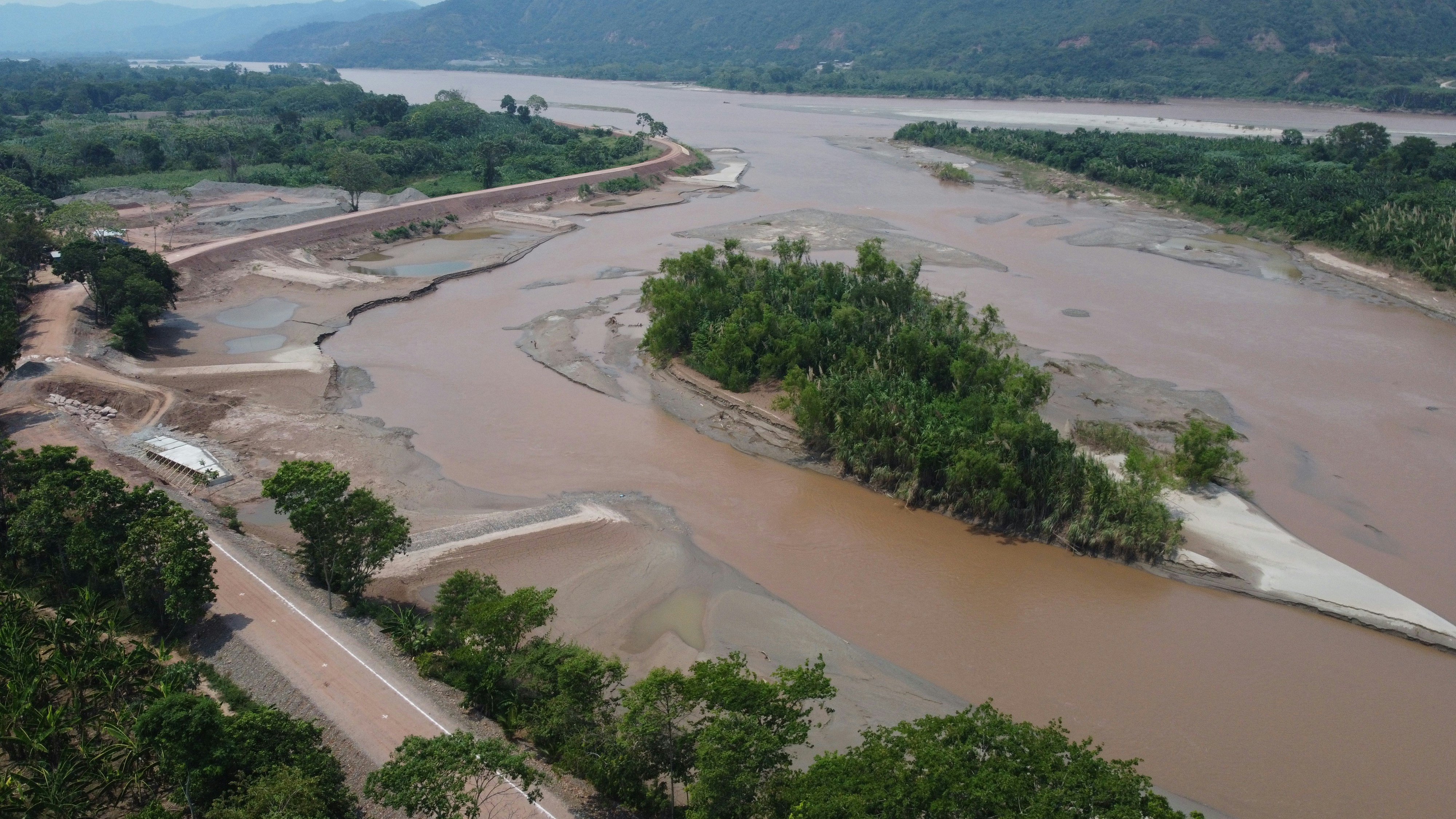 an aerial view of a river and a bridge