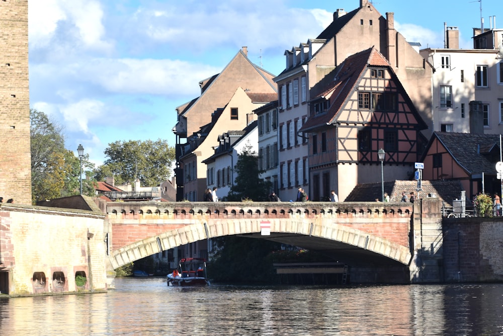 a bridge over a body of water with buildings in the background