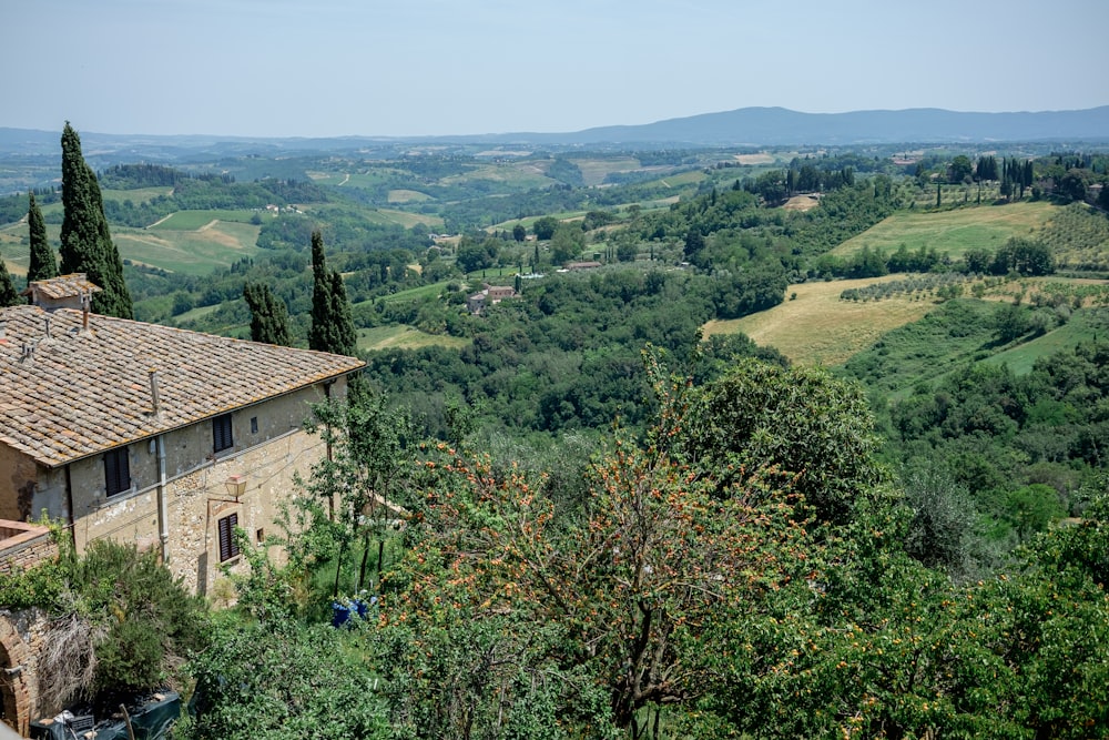 a house in the middle of a lush green valley