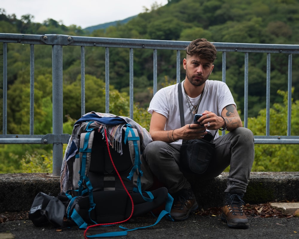 a man sitting on the ground with a camera