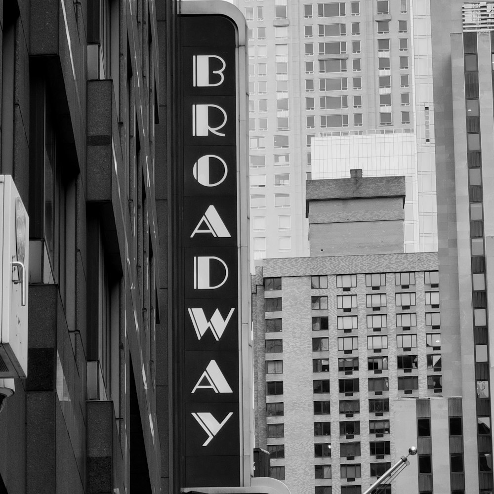 a black and white photo of a broadway sign