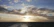 A serene ocean view at dawn with soft golden light filtering through minimalist architectural lines.