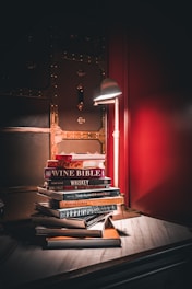 a stack of books sitting on top of a wooden table