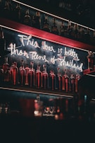 Bar area decorated with neon signs and 90s memorabilia