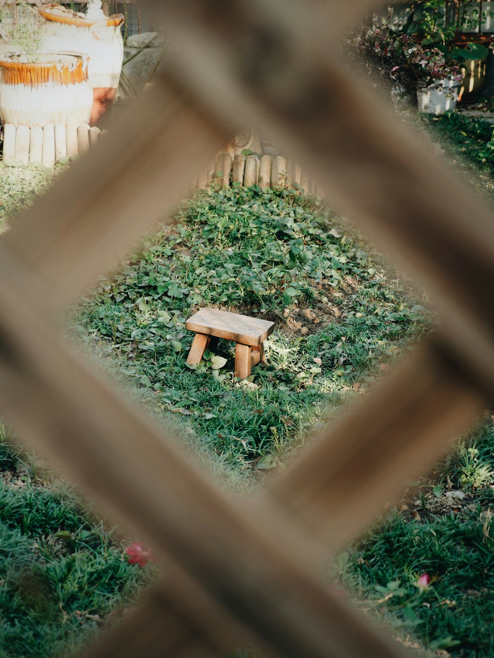 a wooden bench sitting on top of a lush green field