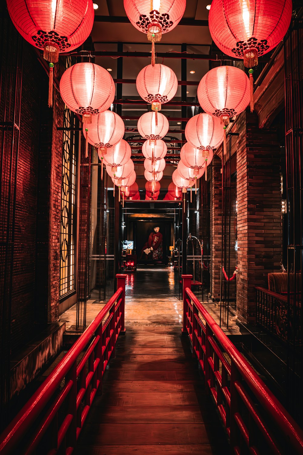 a long hallway with red lanterns hanging from the ceiling