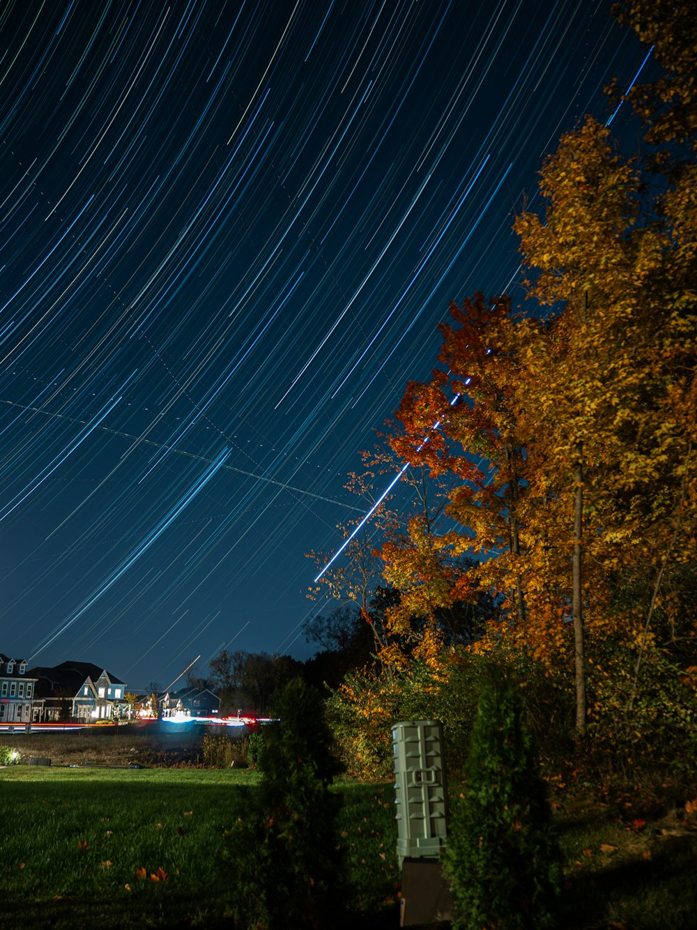 the night sky with a star trail in the background