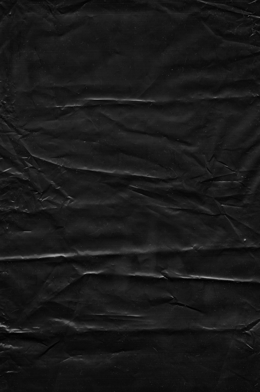 a piece of black paper that has been wrinkled