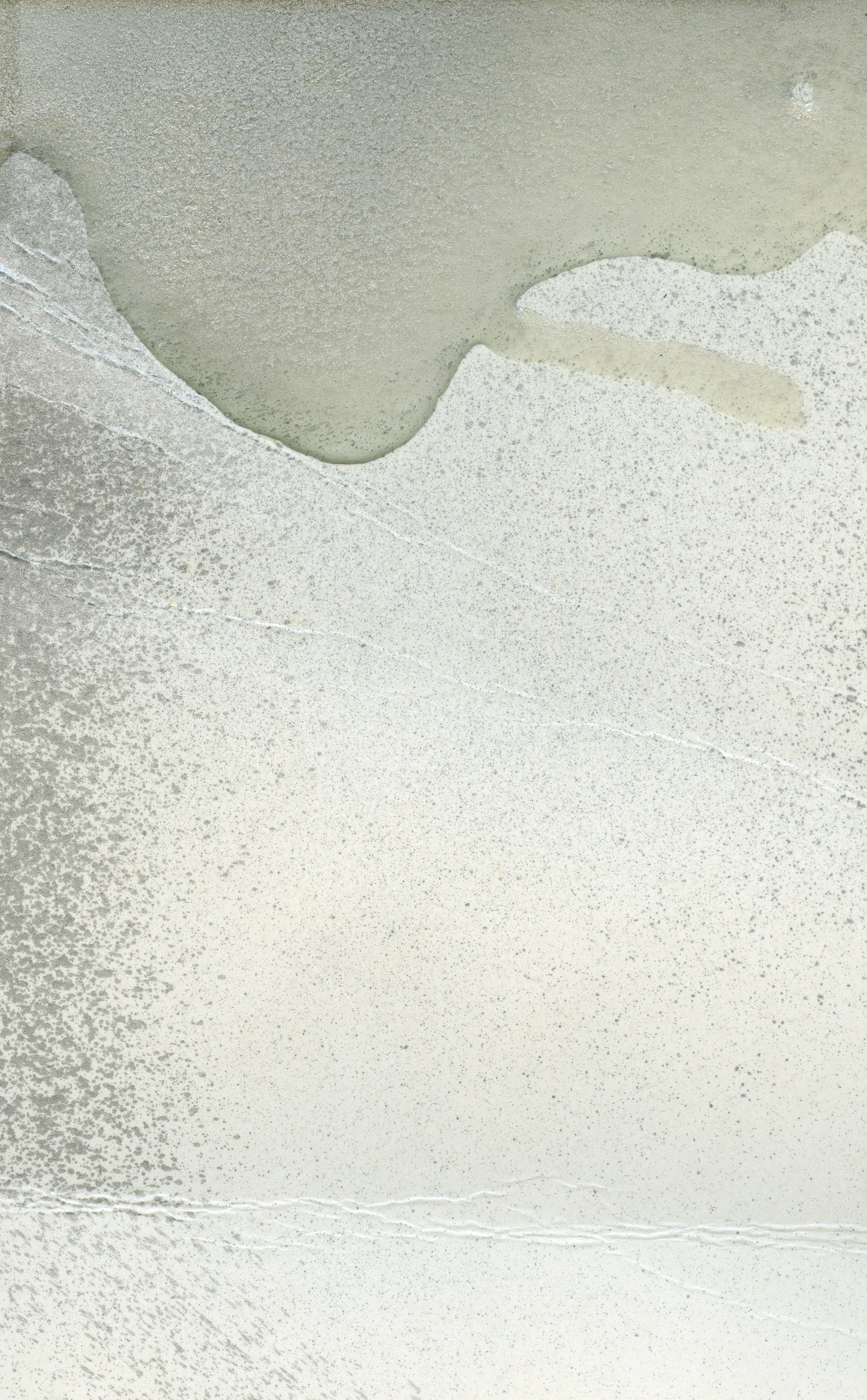 a man riding a surfboard on top of a sandy beach
