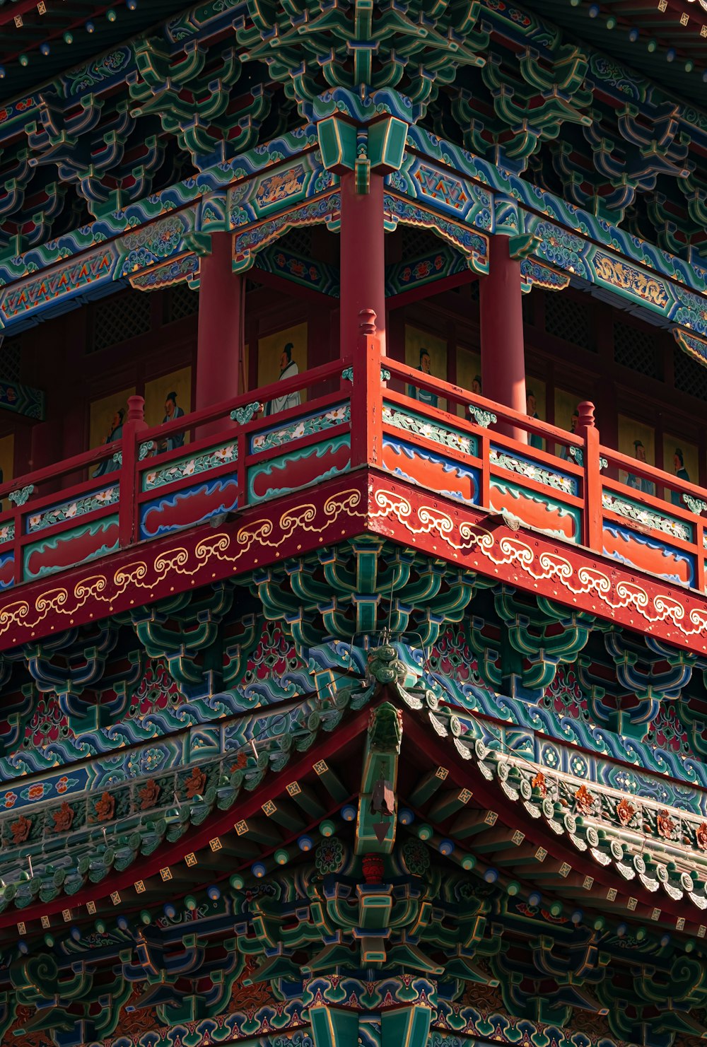 a red and blue building with a red balcony