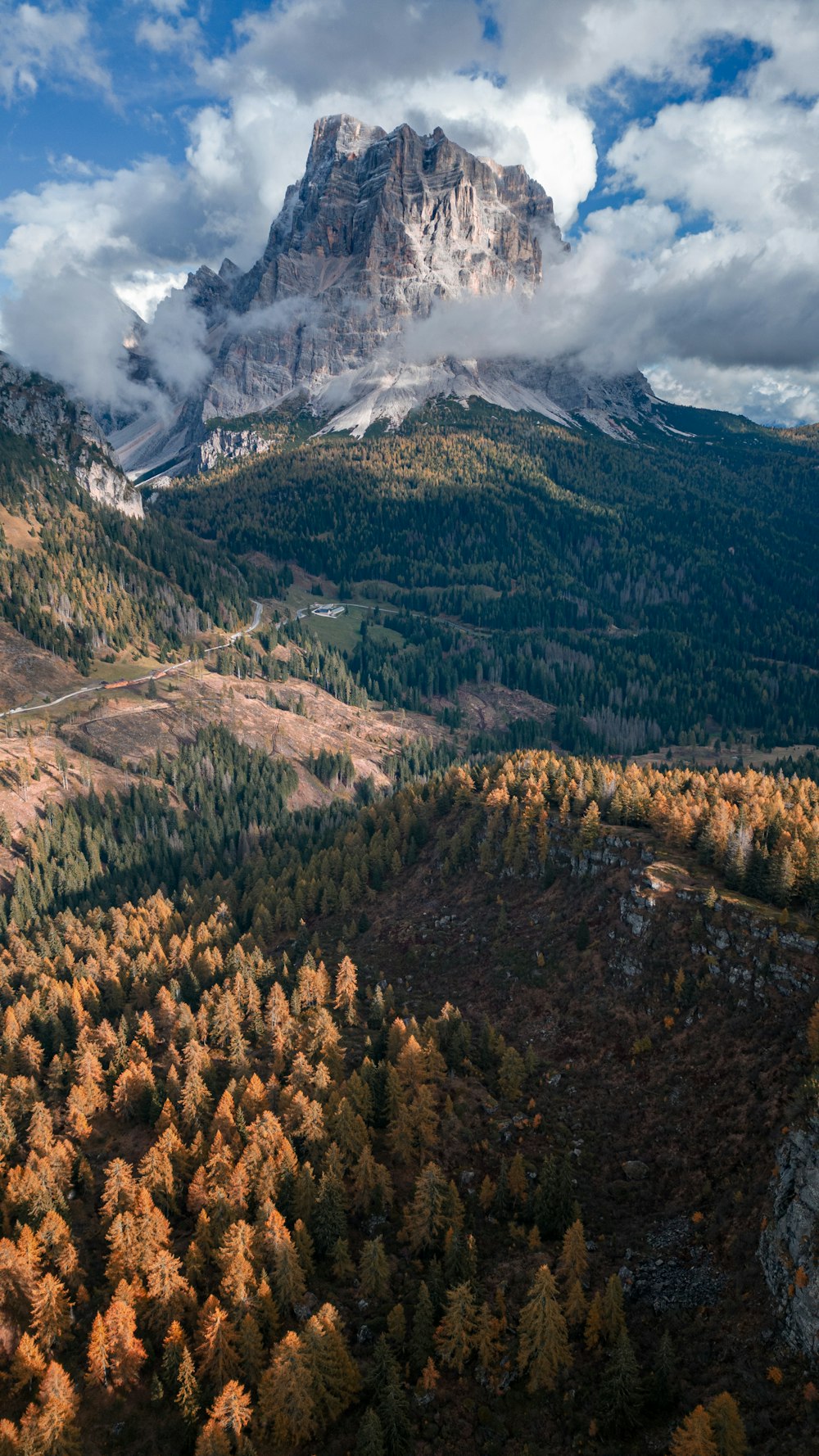 a view of a mountain range with trees in the foreground