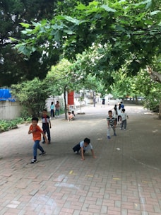 Children exploring a lush Singapore park during an outdoor learning session.
