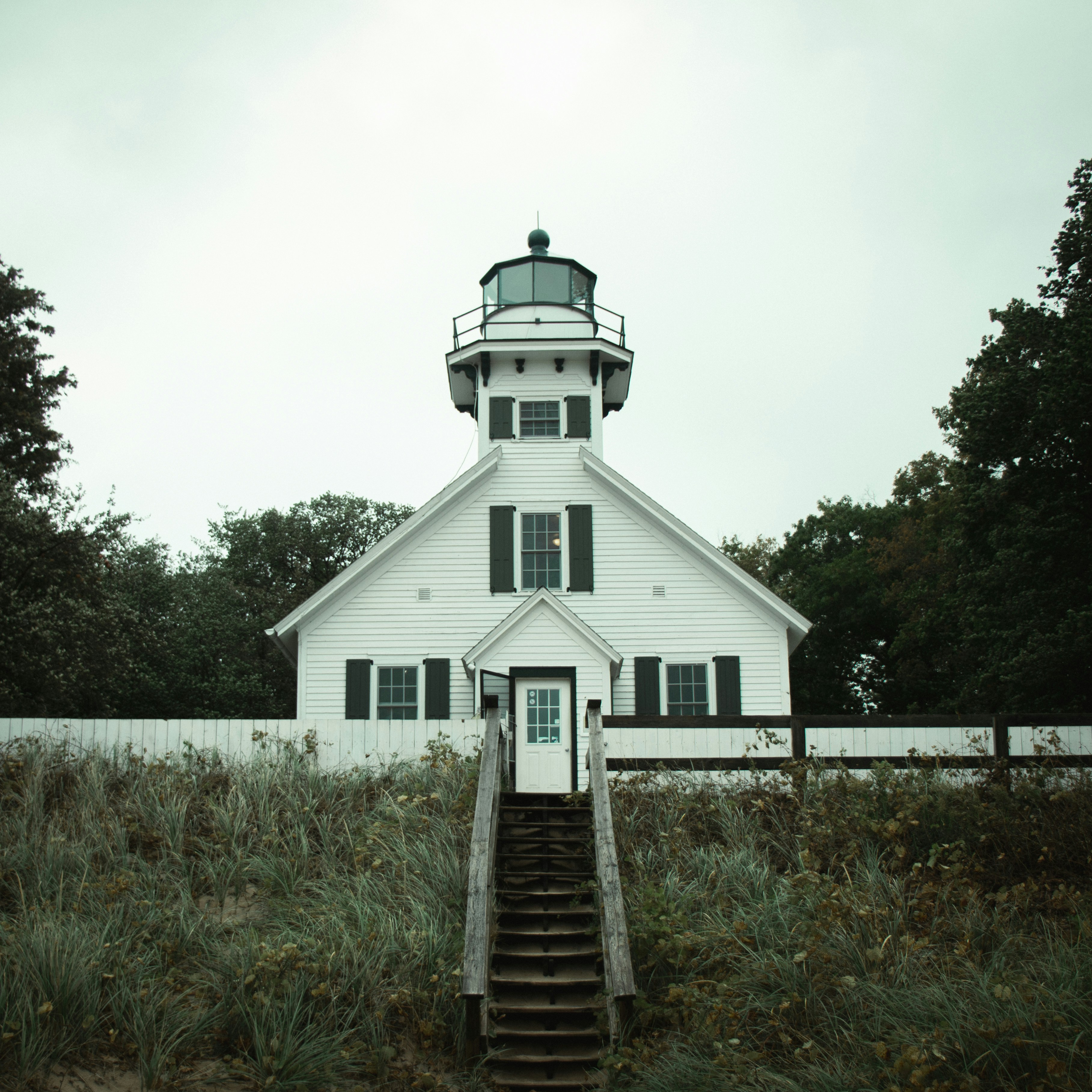 a white house with a light house on top of it