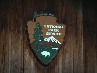 Historic lodge emblem carved in wood, symbolizing heritage and values.
