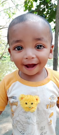 A child happily wearing a comfortable outfit in a park.