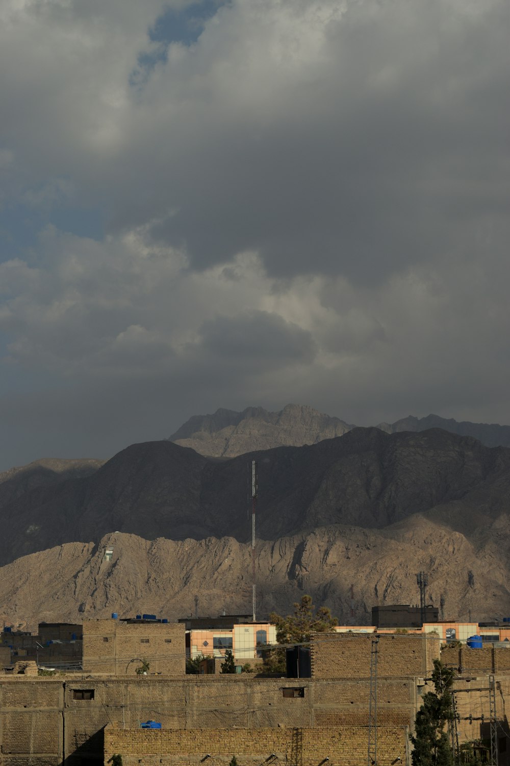 a view of a mountain range with a building in the foreground