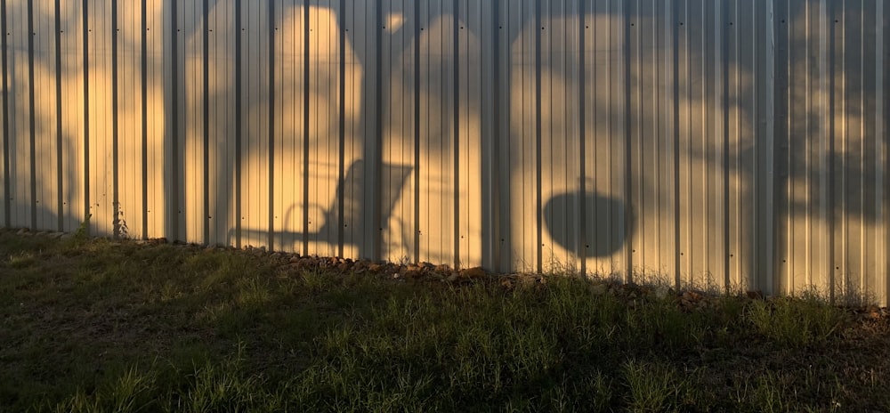 a shadow of a bicycle on a metal wall