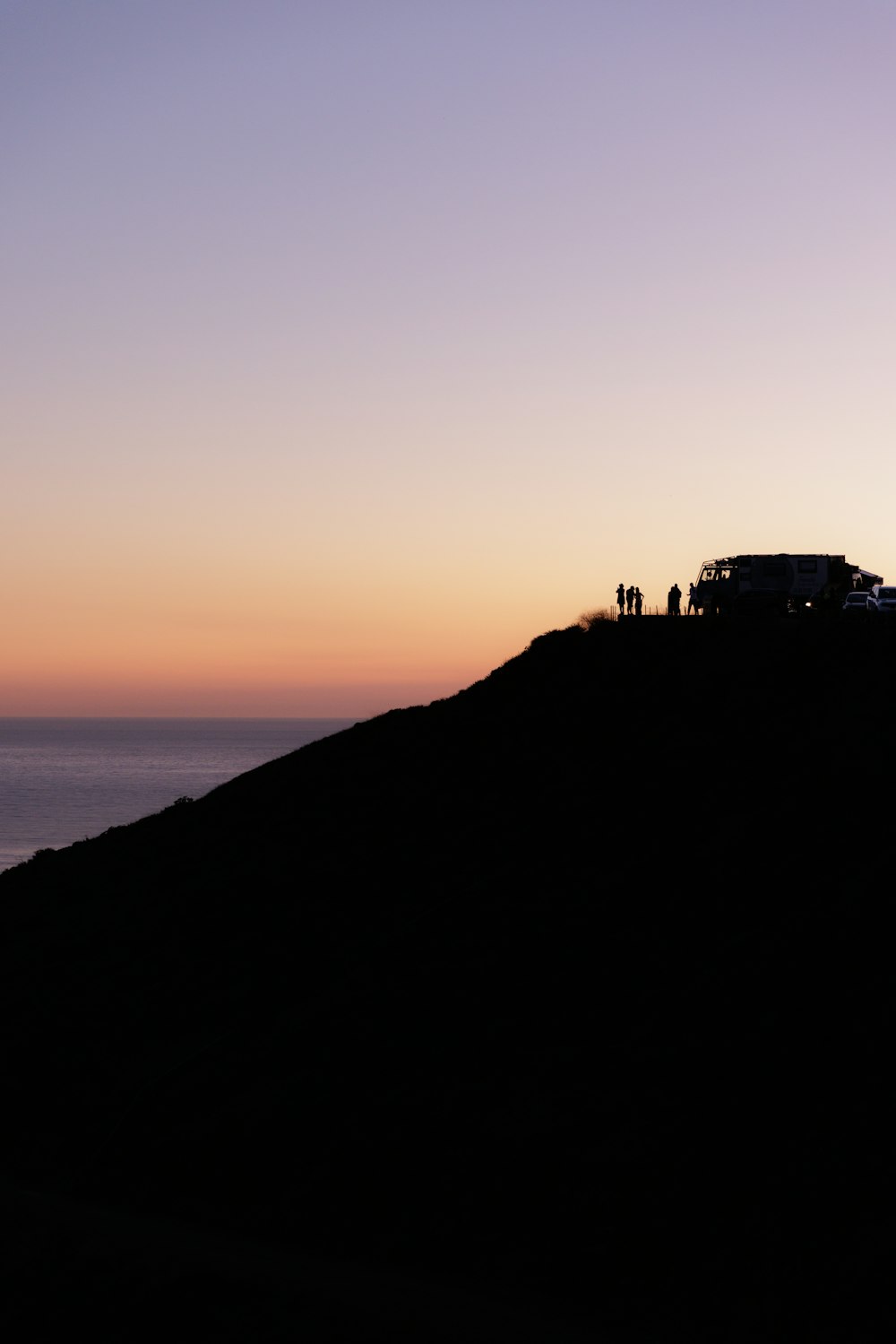 a group of people standing on top of a hill