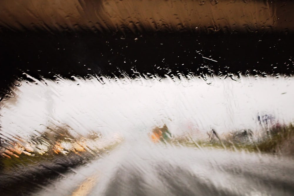 a view of a street through a rain covered window