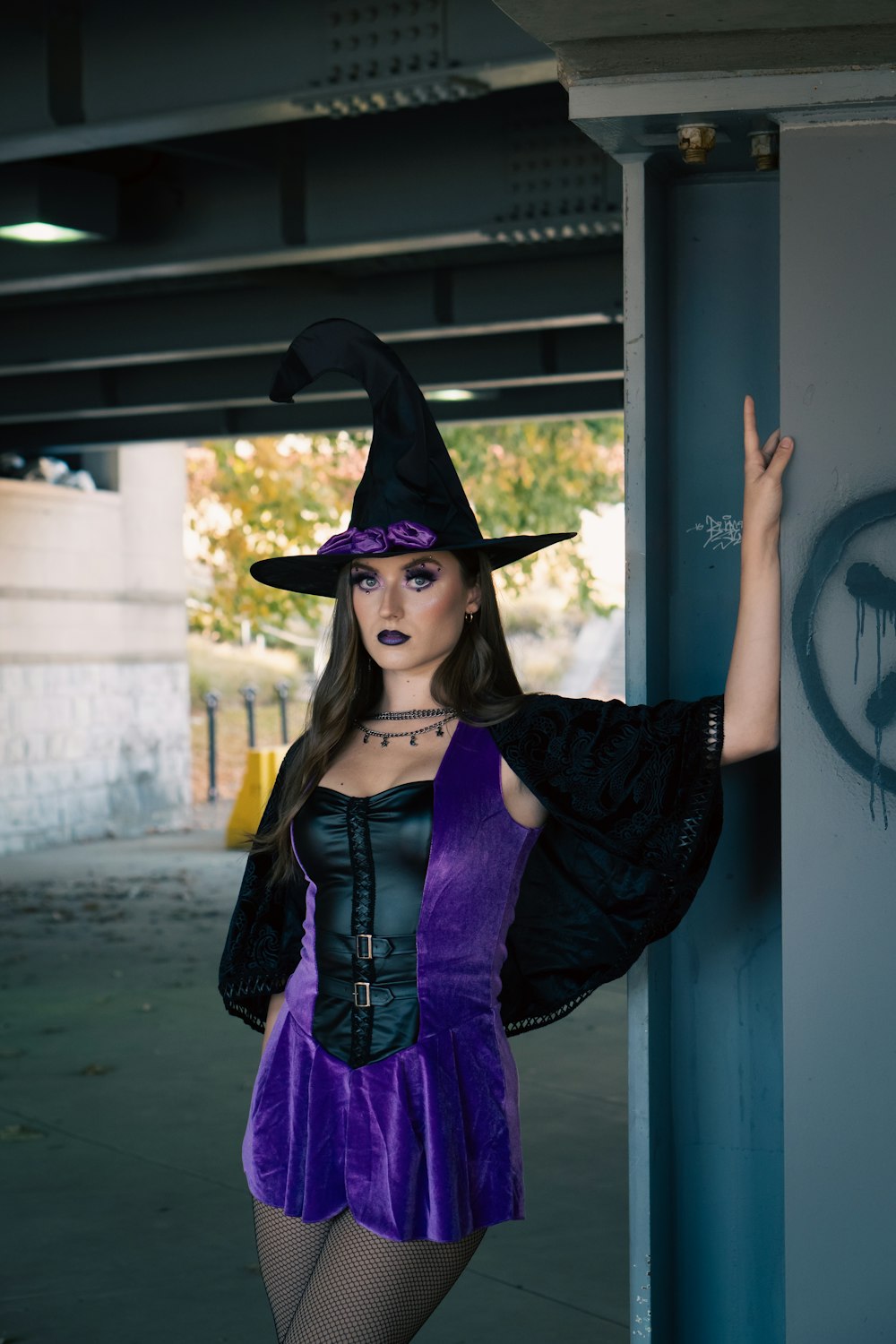 a woman in a witches costume posing for a picture