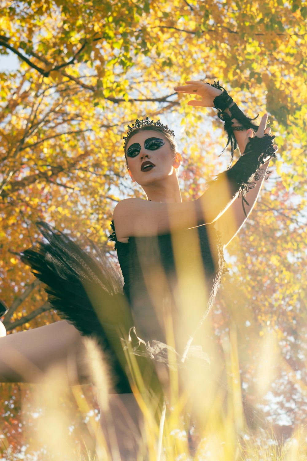 a woman in a black dress and white makeup