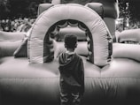 A large castle-themed inflatable jumper in a backyard.