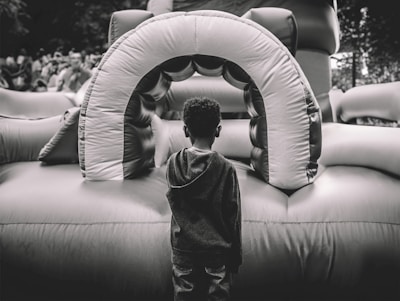 A large castle-themed inflatable jumper in a backyard.