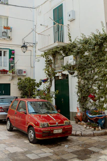 A compact hatchback parked in a charming Algarve village street