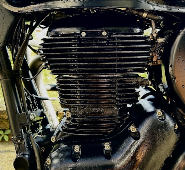 Close-up of rugged small engine gears with red flames and checkerplate background