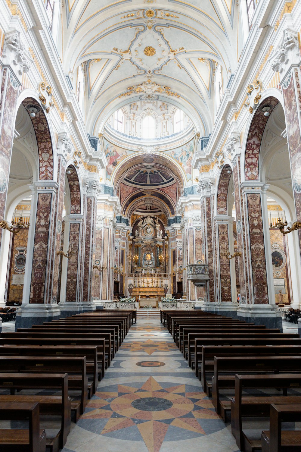 a large church with pews and stained glass windows