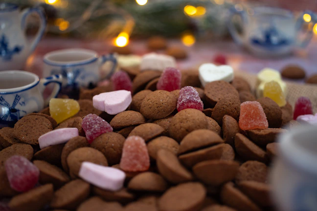 A group gathered around a snack table decorated with puzzle piece motifs and colorful treats.