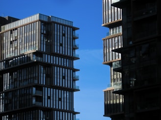 Modern residential buildings with elegant architecture under clear sky.