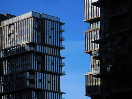 Modern residential buildings with elegant architecture under clear sky.