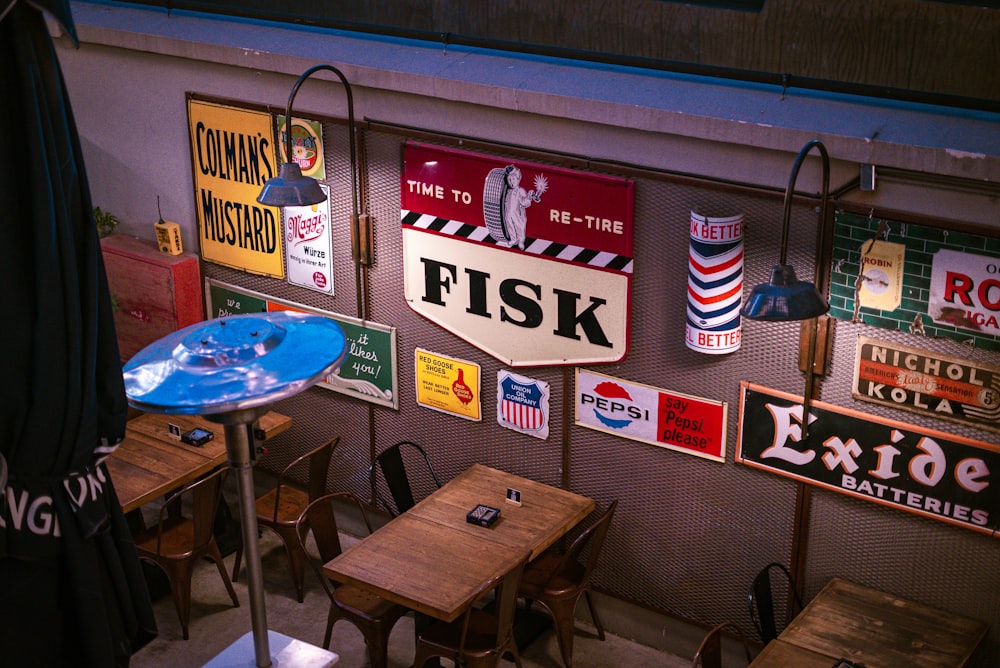 a restaurant with several tables and signs on the wall