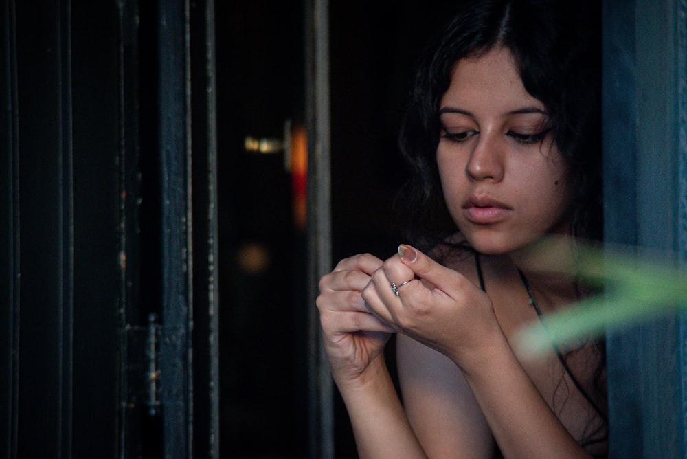 a woman is looking out of a window