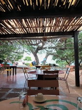 A cozy outdoor seating area surrounding modern containers with beach access in the background.